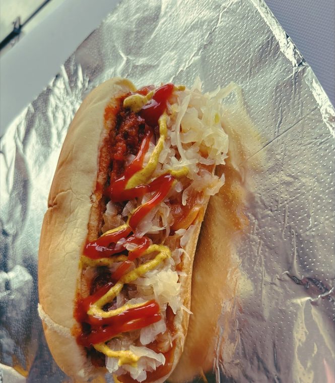 A build your own dirty dog with chili, sauerkraut, ketchup and mustard